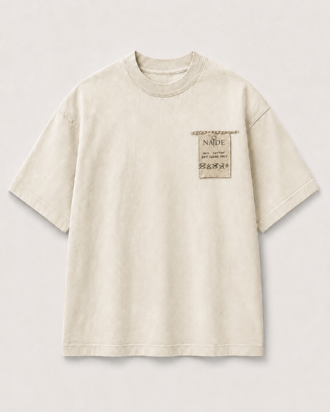 NADE cream oversized T-shirt with small left-chest care-label patch