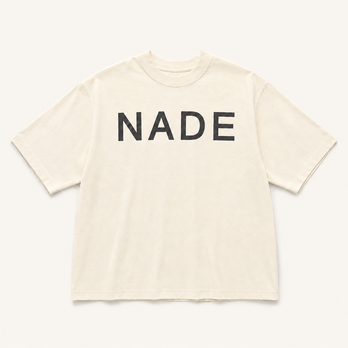 NADE Essential Logo Tee — Cream product view on warm off-white background