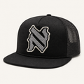 NADE N-Patch Trucker Hat — Black product view on warm off-white background