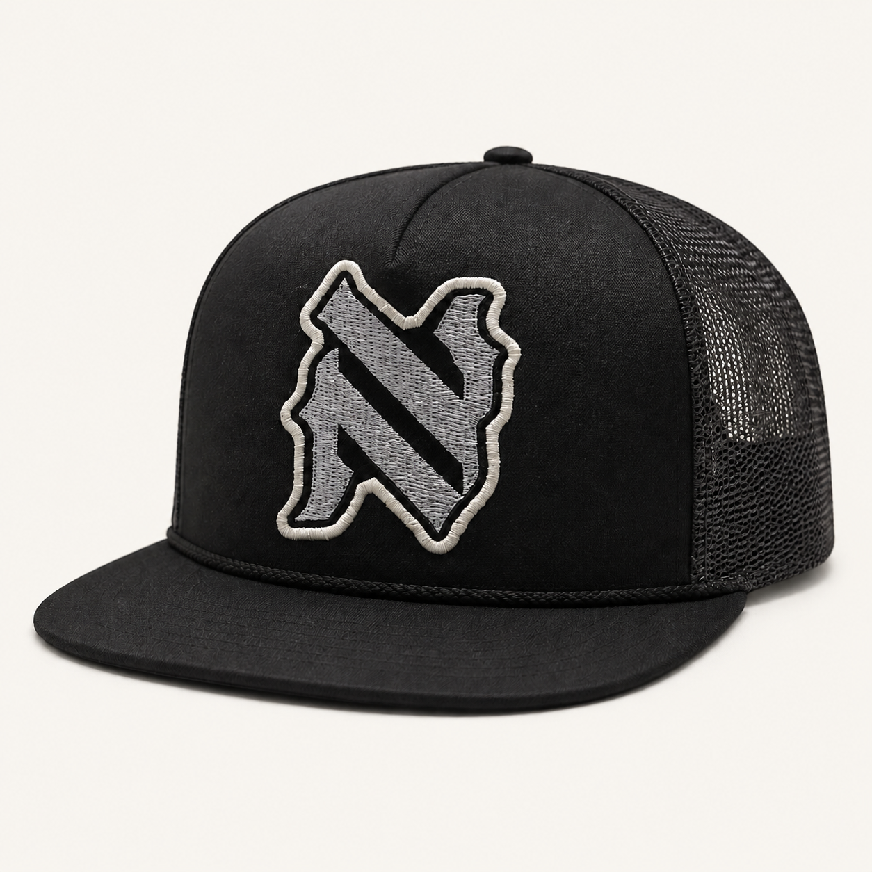 NADE N-Patch Trucker Hat — Black product view on warm off-white background
