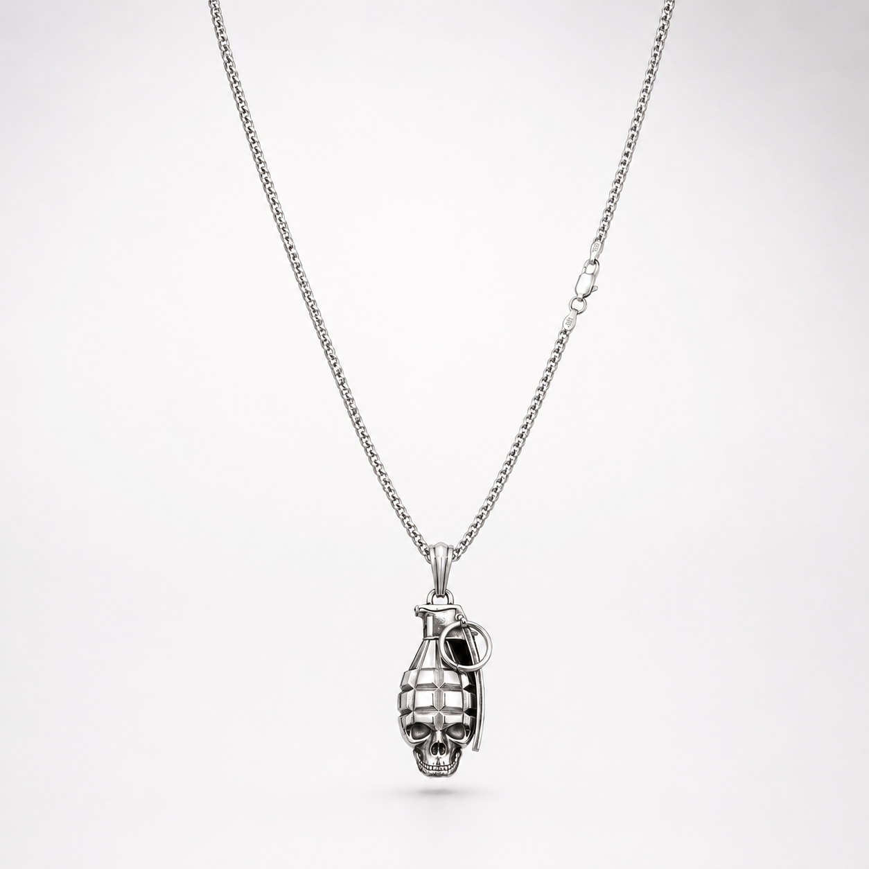 Silver skull grenade pendant necklace on white background